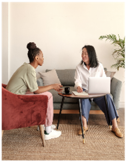 Women chatting around computer